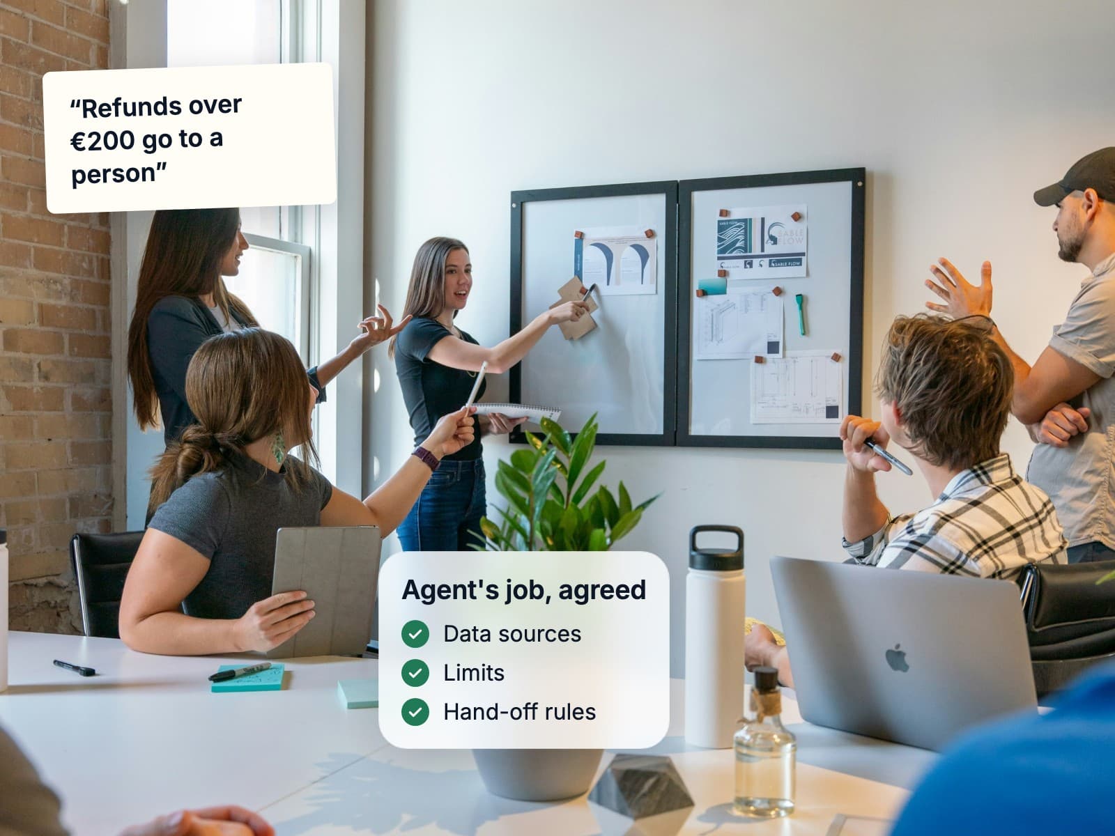 A team mapping an agent's job on a whiteboard in a workshop