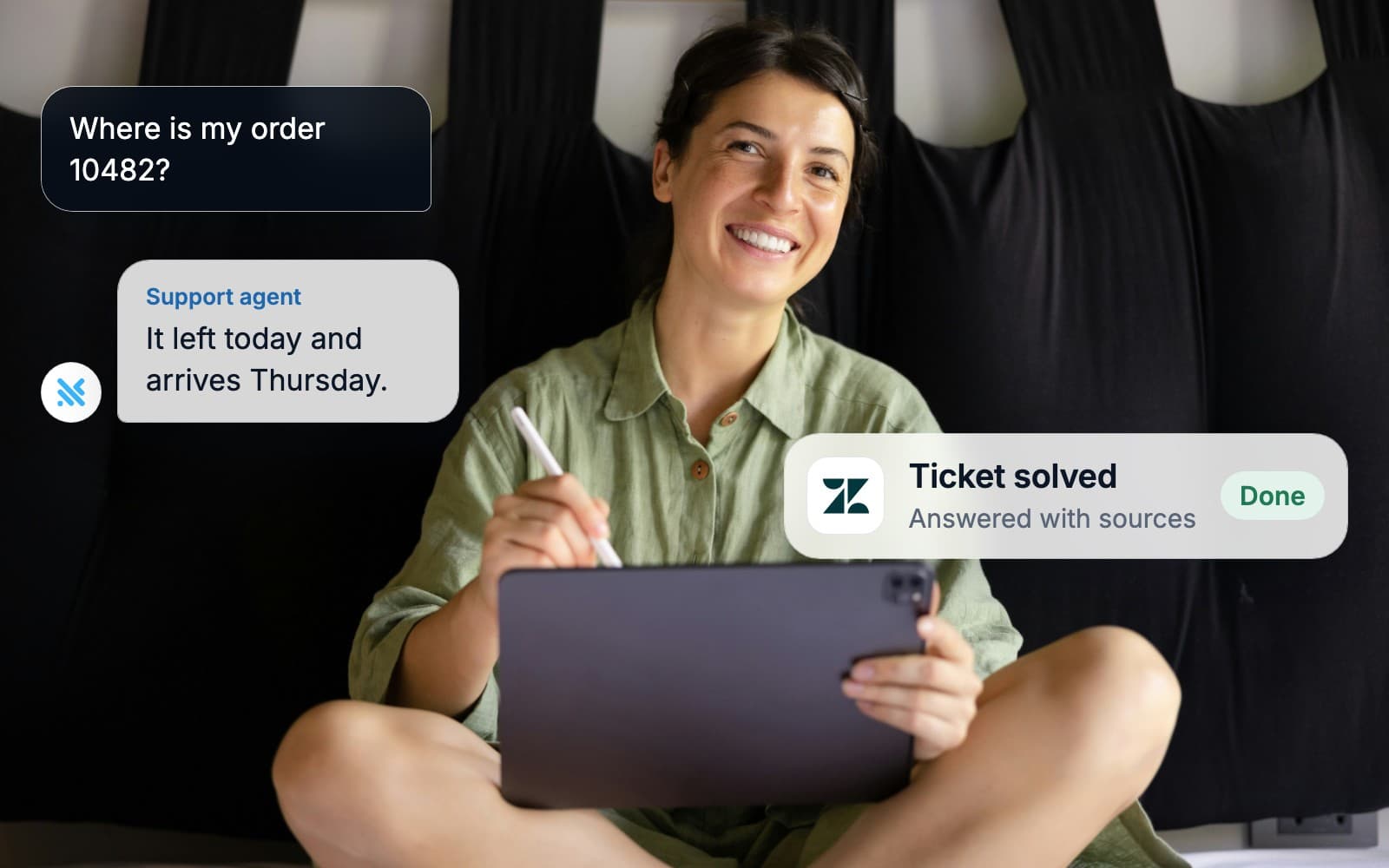A woman with a tablet smiling while an AI agent answers a customer and updates the ticket