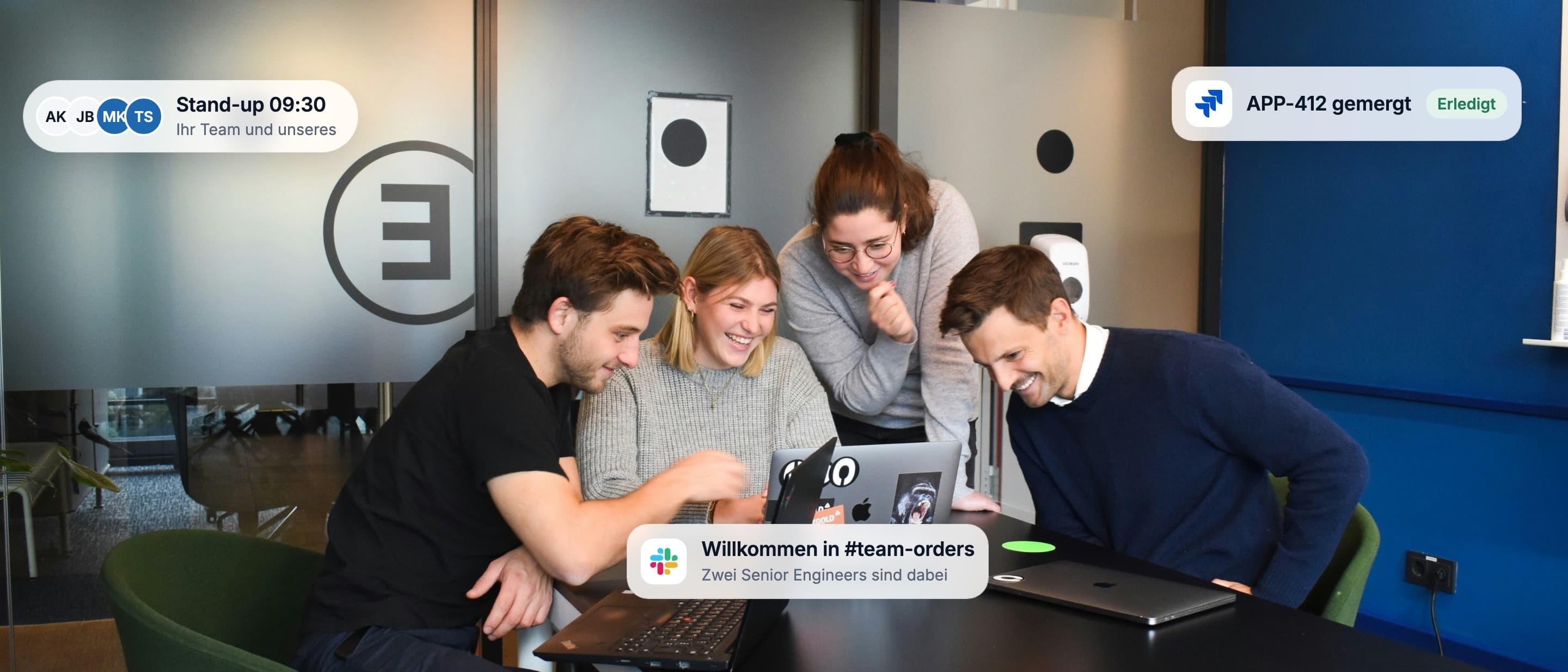 Three engineers working through a change together on one laptop